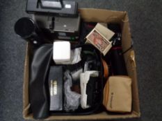 A box containing Zeiss projector, camera equipment, cameras, lenses cases,