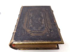 A 19th century leather and brass bound family Holy Bible with colour lithographic book plates