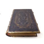 A 19th century leather and brass bound family Holy Bible with colour lithographic book plates