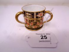 A Royal Crown Derby Imari pattern triple-handled loving cup, height 4 cm.