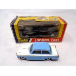 A Dinky 284 London taxi in original box together with a Dinky Toys 189 Triumph Herald