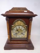 A late 19th century German striking 8 day mantel clock with brass and silvered dial