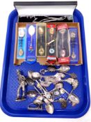 A tray of a quantity of crested spoons, metal figure of a musician,