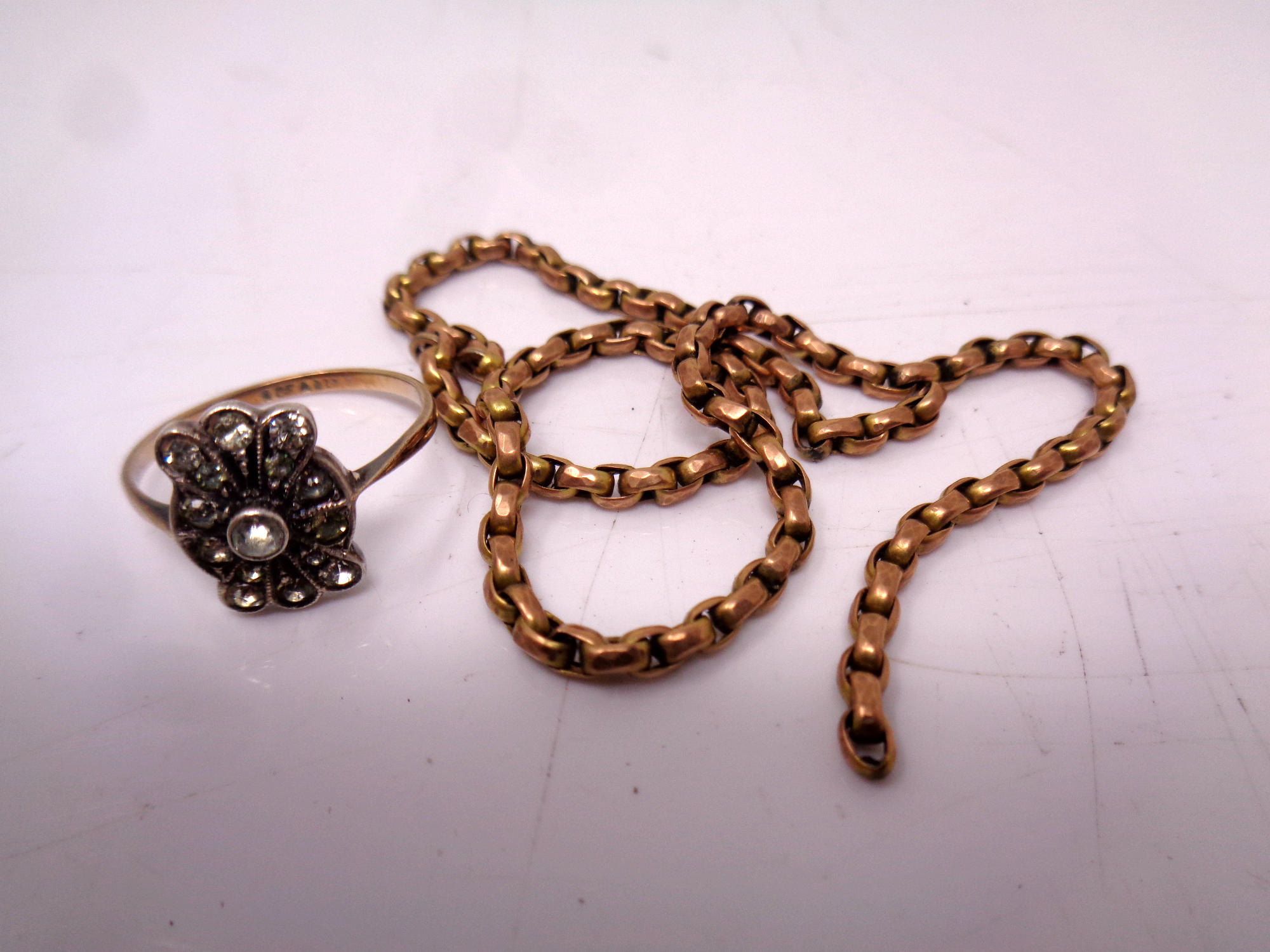 A 9ct gold dress ring and a gold-coloured chain fragment.