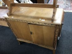 A carved oak two door side cabinet