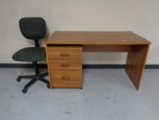 An office desk together with a three drawer under desk chest and a swivel typists chair.