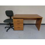 An office desk together with a three drawer under desk chest and a swivel typists chair.