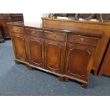 A Regency style mahogany four drawer break fronted sideboard