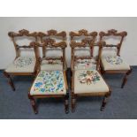 A set of six carved rosewood dining chairs with embroidered seat pads