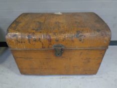 An antique dome topped tin trunk.