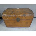 An antique dome topped tin trunk.