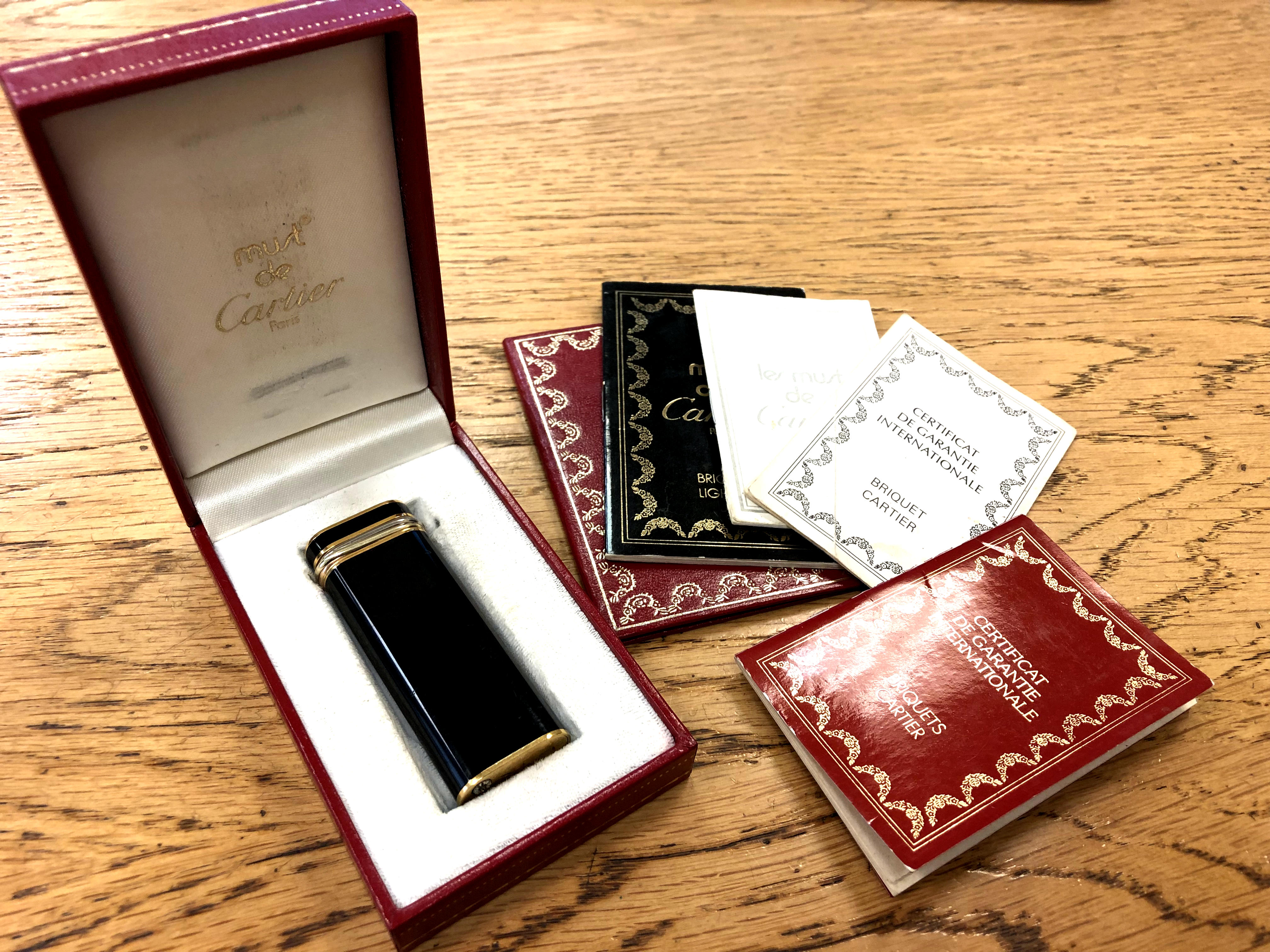A must de Cartier gold-plated and black enamel lighter, circa 1989, stamped 62450T,