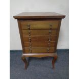 An Edwardian mahogany music cabinet