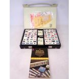 A Mahjong set in case together with accompanying book