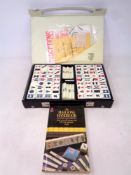 A Mahjong set in case together with accompanying book