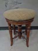 A Victorian beech circular piano stool