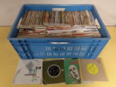 A crate containing a large quantity of vinyl 7" singles to include Neil Diamond, Queen, The Beatles,