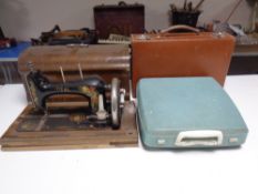 An Ideal vintage hand sewing machine in case together with a typewriter and a leather luggage case.