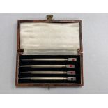 Four silver and enamel bridge pencils, cased.