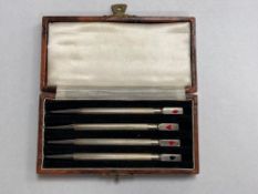 Four silver and enamel bridge pencils, cased.