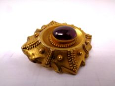 A Victorian pinchbeck brooch with amethyst cabochon