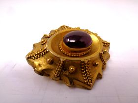 A Victorian pinchbeck brooch with amethyst cabochon