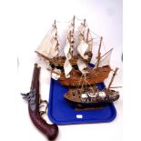 A replica flintlock pistol together with three wooden boats, a fishing trawler,