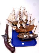 A replica flintlock pistol together with three wooden boats, a fishing trawler,