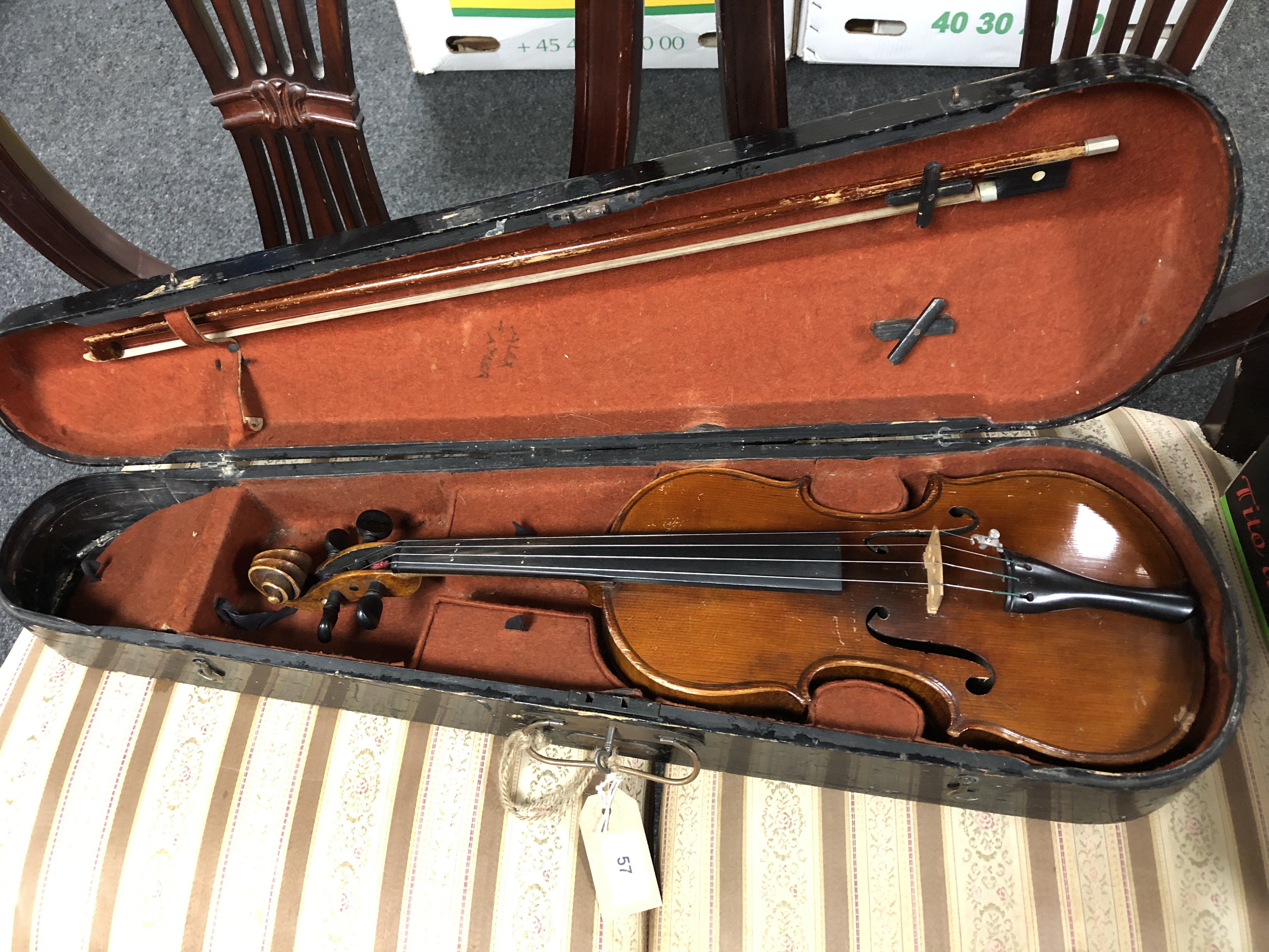 An antique violin with two-piece 13" back, with bow, in coffin case.