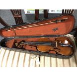 An antique violin with two-piece 13" back, with bow, in coffin case.