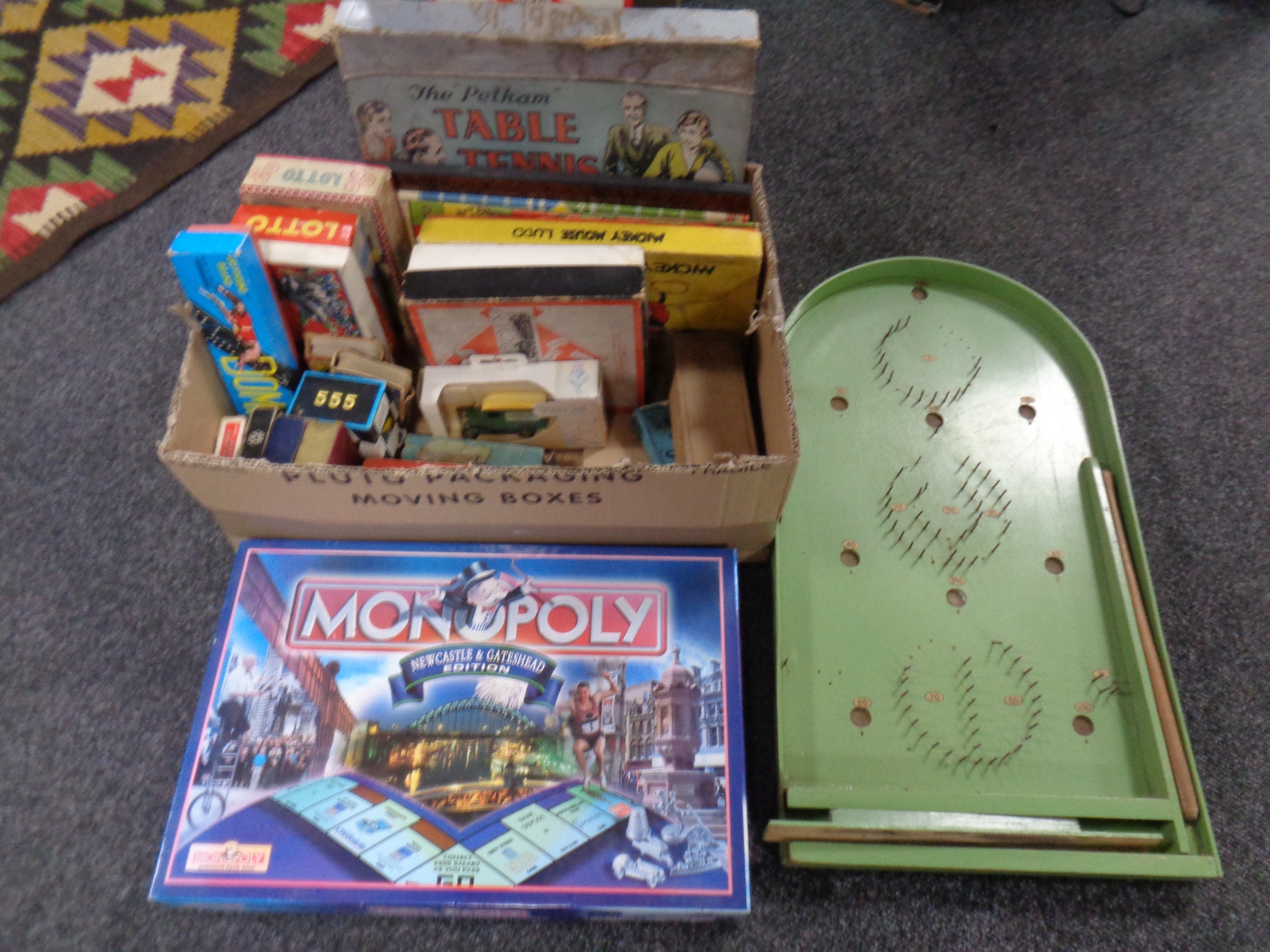 A box containing vintage and later games to include Pelham stable tennis, Mickey Mouse Ludo,