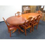 A yewwood extending dining table with leaf together with a set of six dining chairs