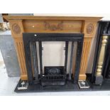 A cast iron Art Nouveau tiled fire insert with carved oak surround and black marble hearth.