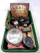 A box containing vintage car dashboard meters, Lucas headlights,