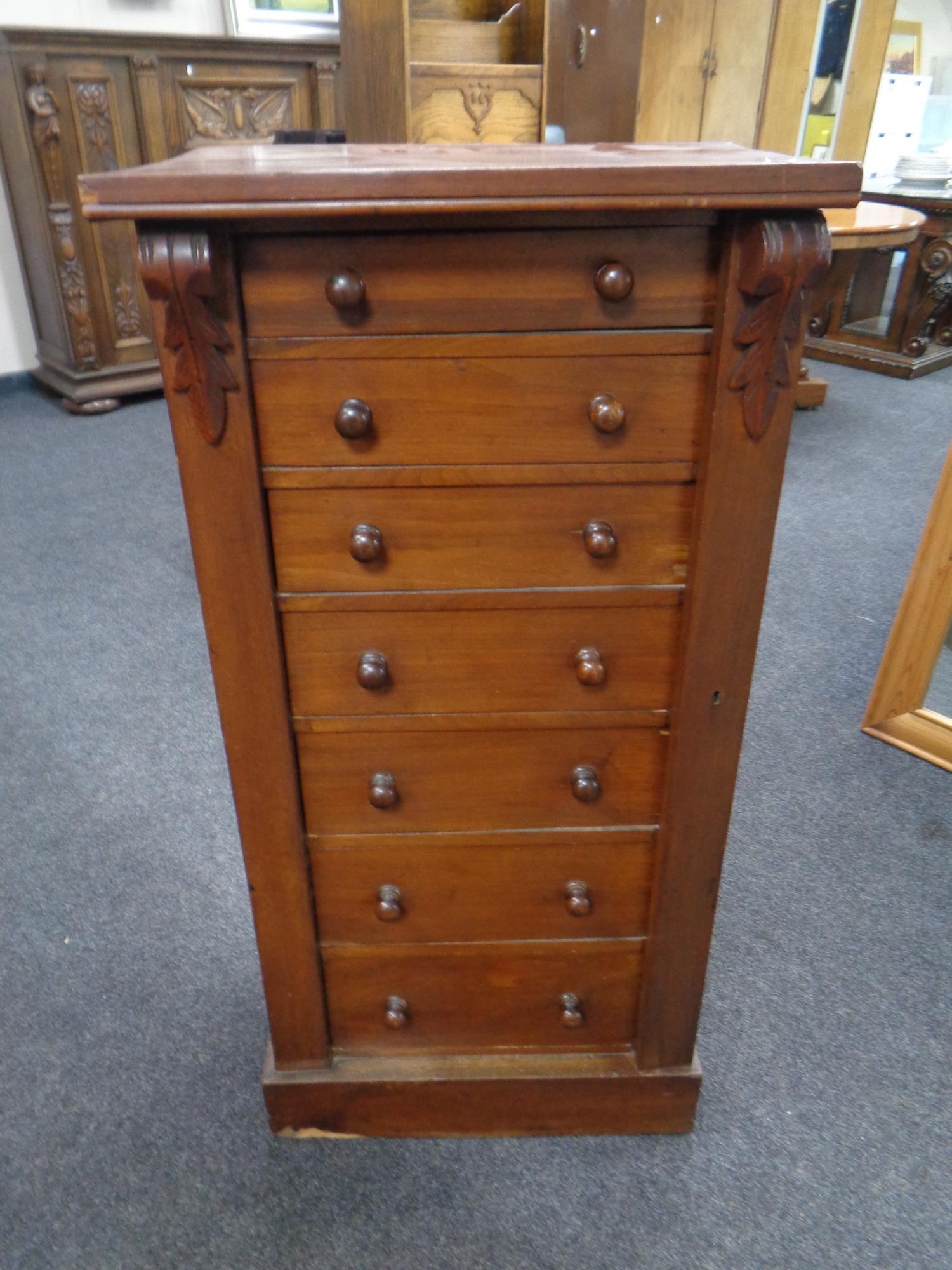 A Victorian stained pine Wellington chest fitted seven drawers