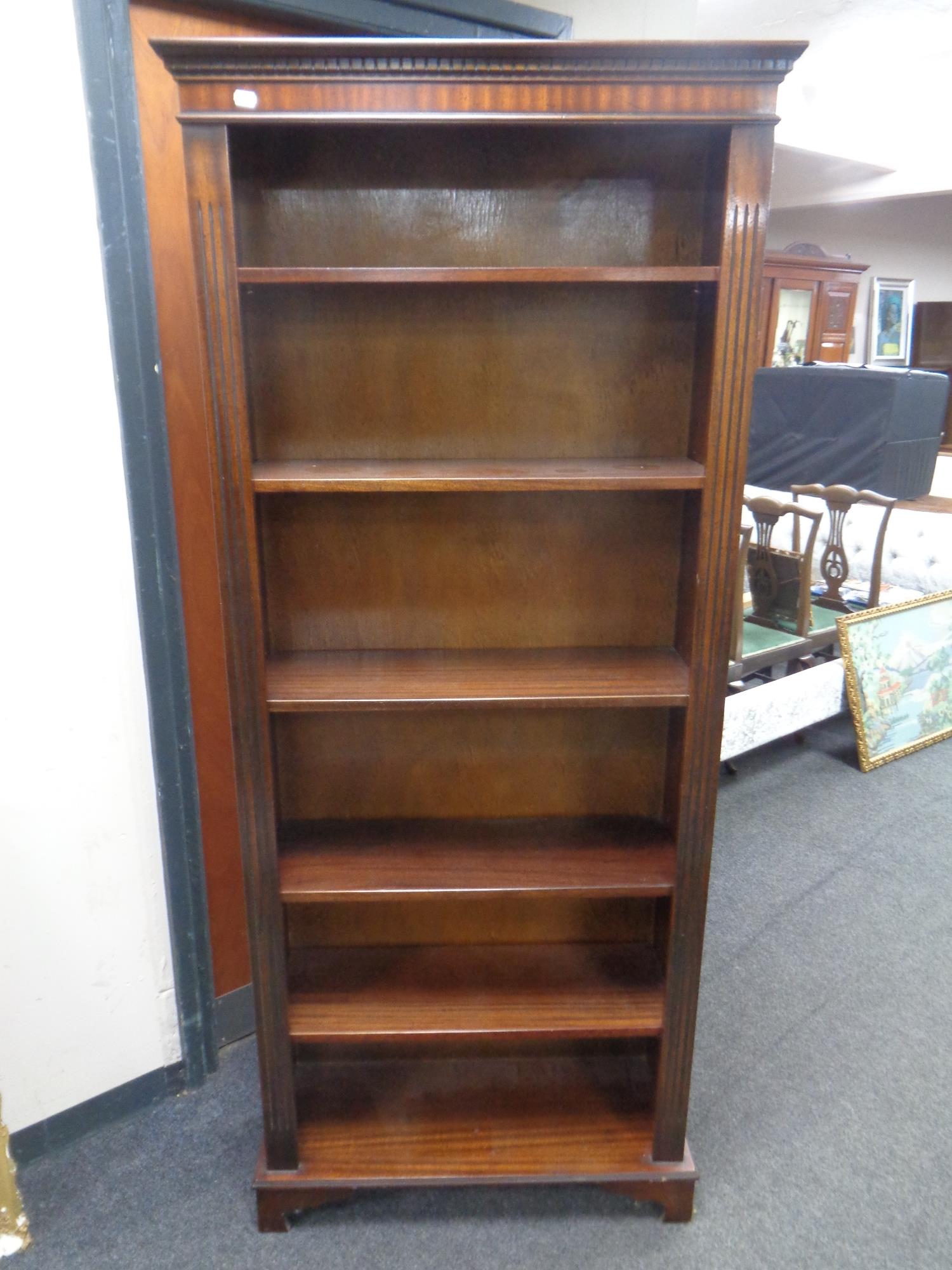 A set of open book shelves in a mahogany finish