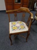 An Edwardian inlaid mahogany corner chair with tapestry seat