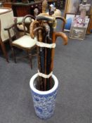 A blue and white oriental style glazed ceramic stick stand containing a quantity of vintage walking