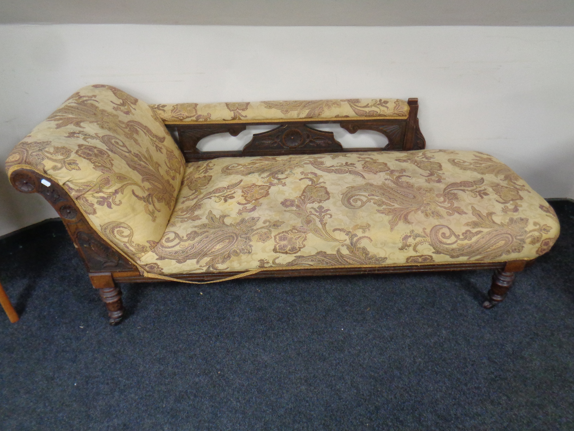 A 19th century carved mahogany chaise longue upholstered in a paisley fabric