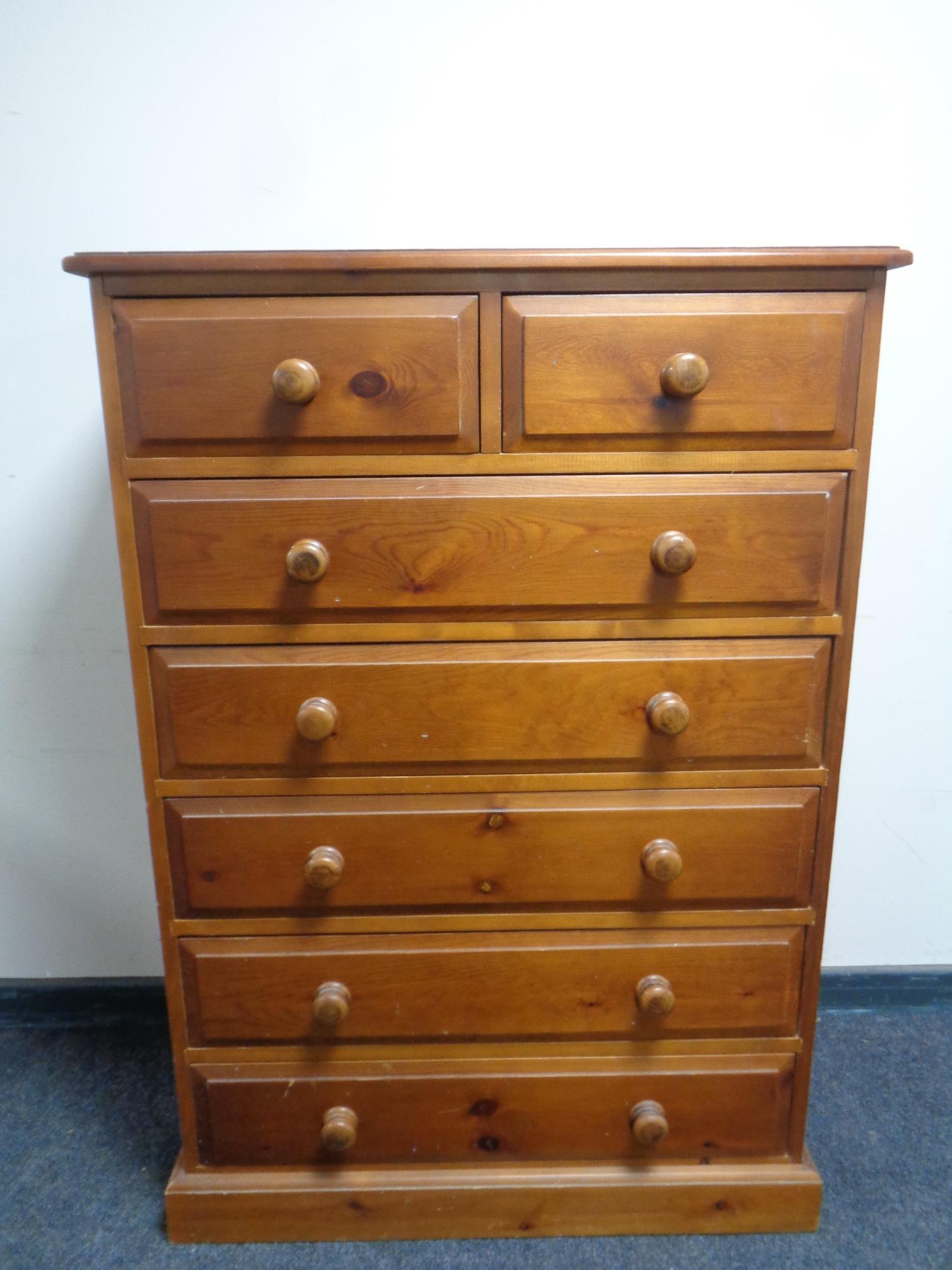 A pine chest of seven drawers