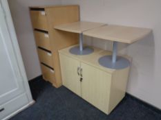 A pine effect four drawer office filing cabinet together with double door stationary cupboard and