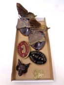 A box containing metal items to include a bronze fox head, a horse brass,