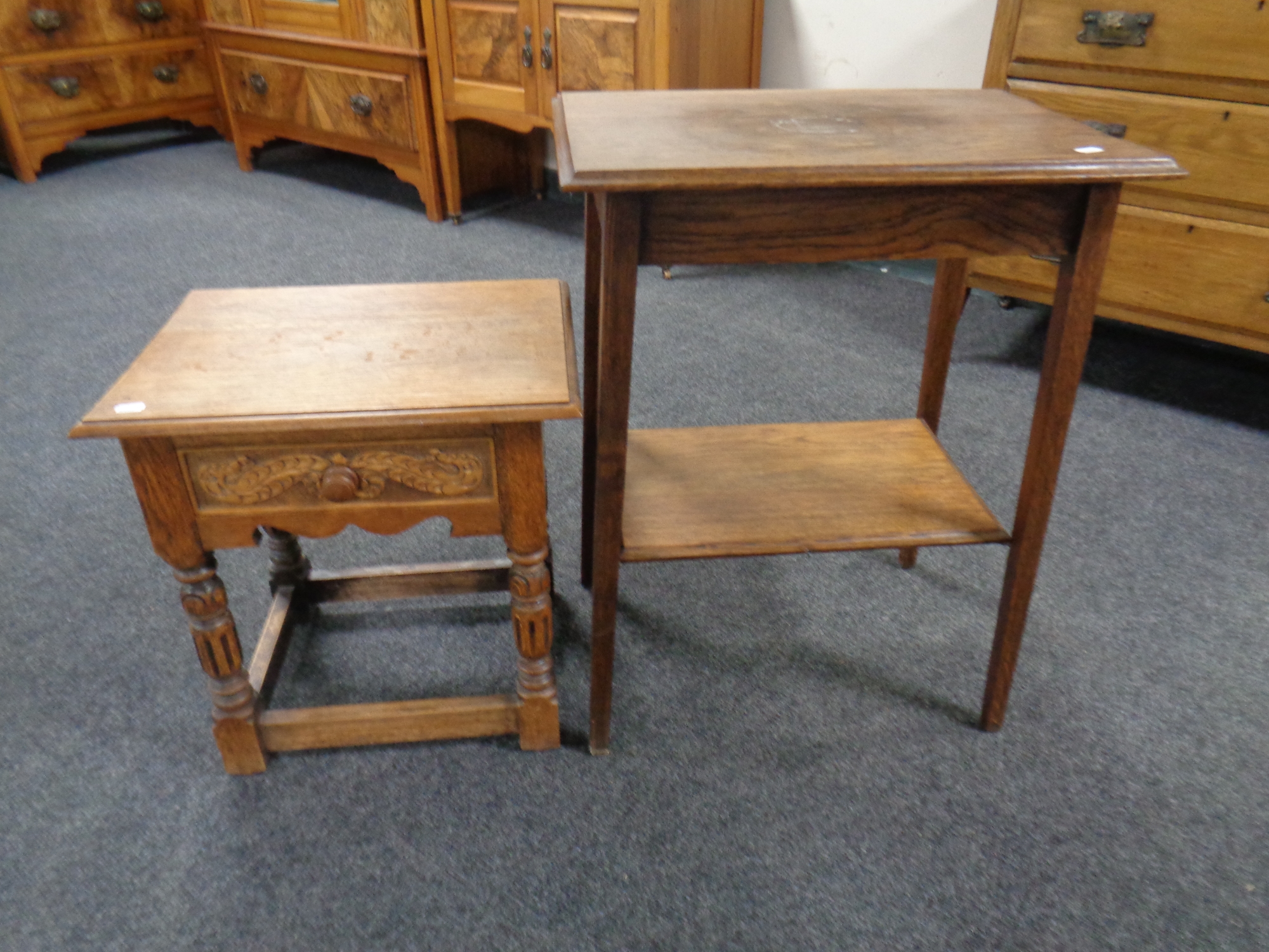 An Edwardian two-tier oak table together with a similar table fitted a drawer