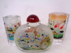 A Chinese over sized glass bottle together with two octagonal brush pots
