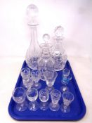 A tray containing three cut glass decanters with stoppers together with assorted antique and later