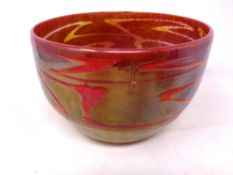 A circular art glass bowl red and iridescent (diameter 20 cm) indistinctively signed to base