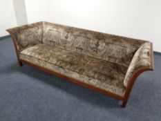 A mahogany framed Regency style low settee in classical upholstery