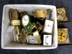 A basket of contemporary mantel clocks and a further metal mantel clock