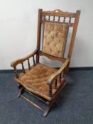 An Edwardian beech framed rocking chair