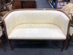 A 19th century mahogany low back window settee upholstered in a classical fabric